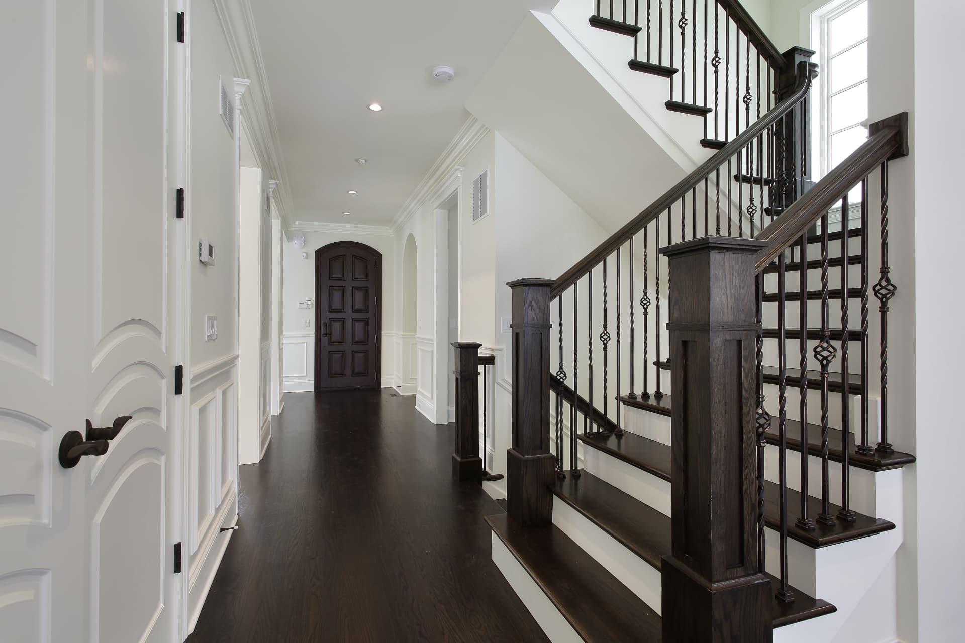 Custom staircase with iron balusters, crown molding, and finish carpentry, Sioux Falls South Dakota