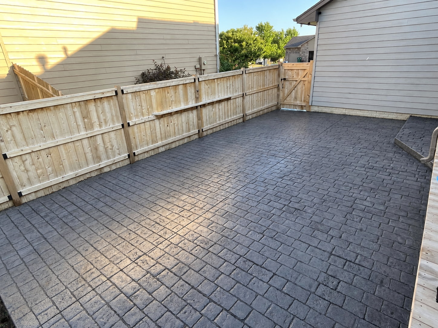 Stamped concrete cobblestone patio and outdoor living area built by Qualified Carpentry in Sioux Falls South Dakota