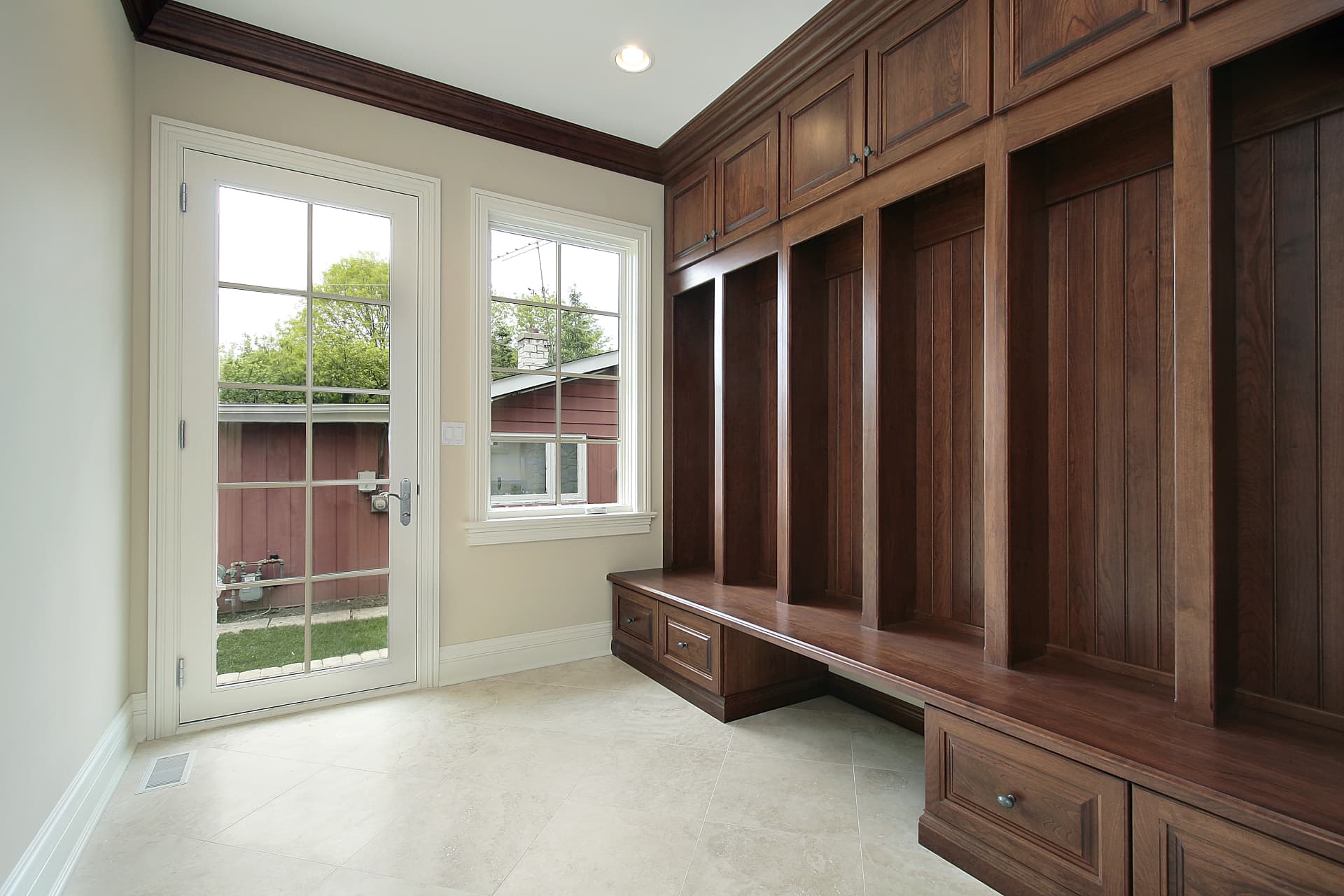 Custom walnut mudroom with built-in cabinetry and bench seating, Sioux Falls South Dakota