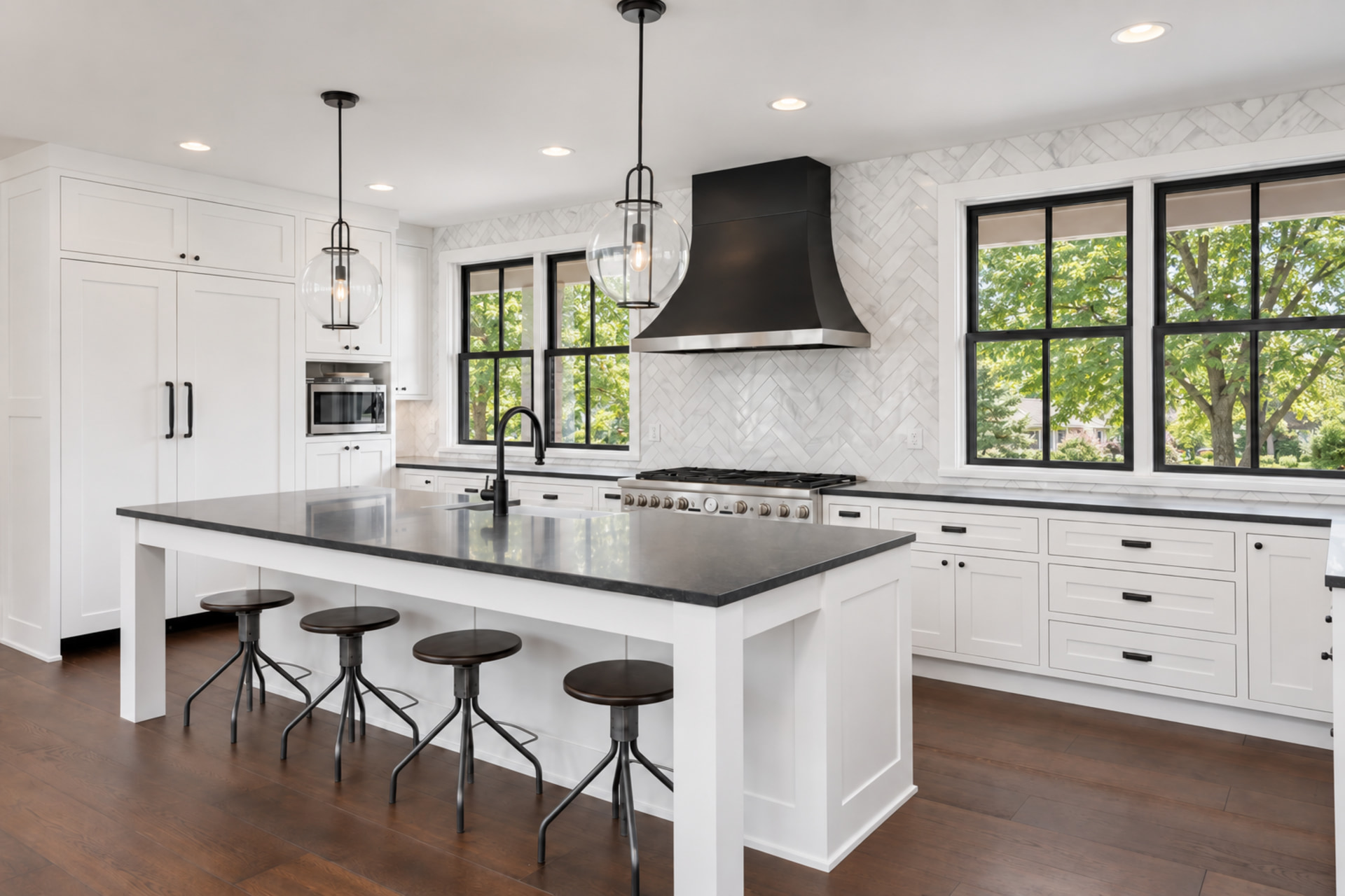 Custom kitchen remodel with white cabinets, black vent hood, and island, Sioux Falls South Dakota