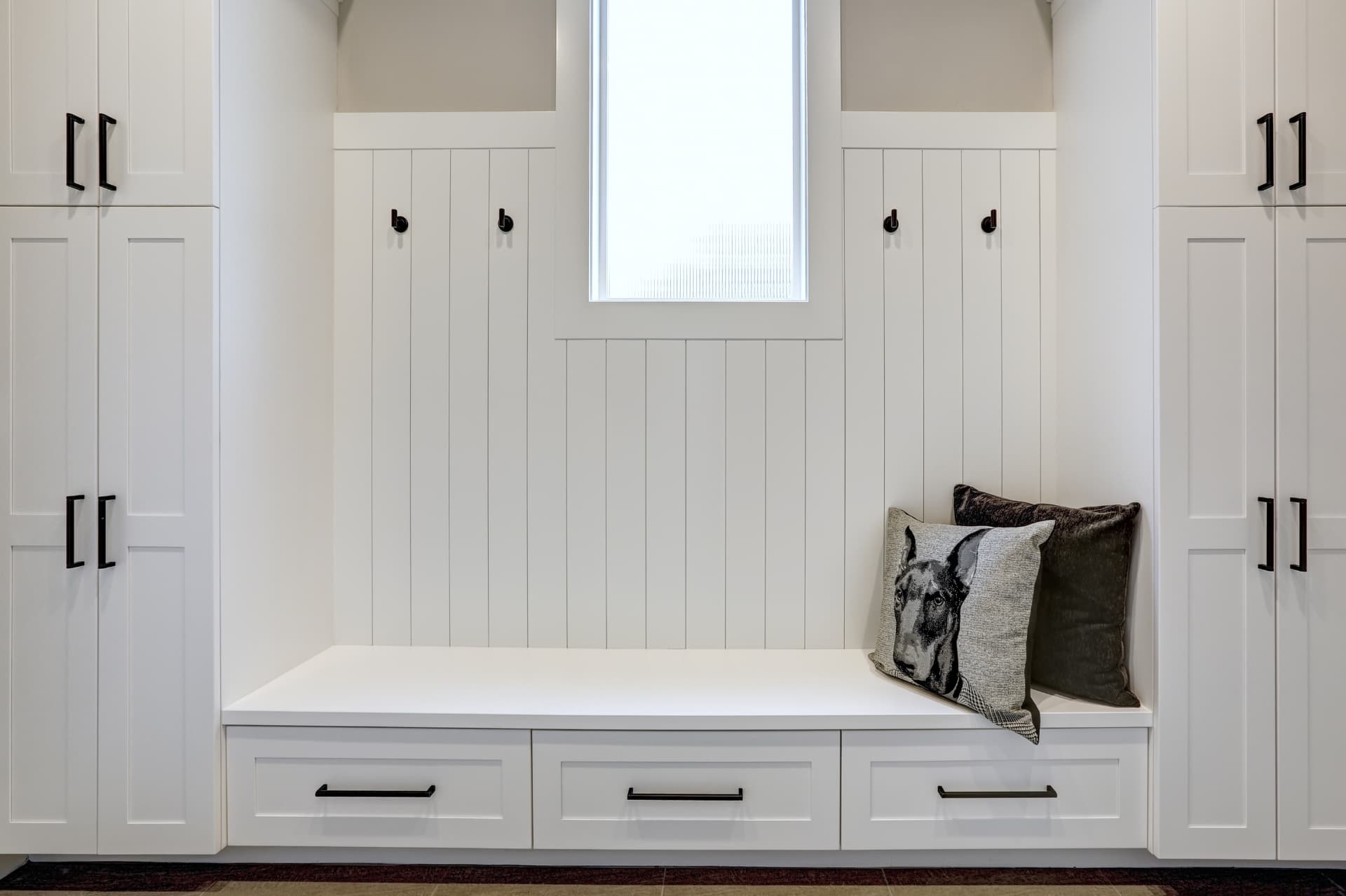 Custom mudroom cabinetry with white shaker cabinets and built-in bench, Sioux Falls South Dakota